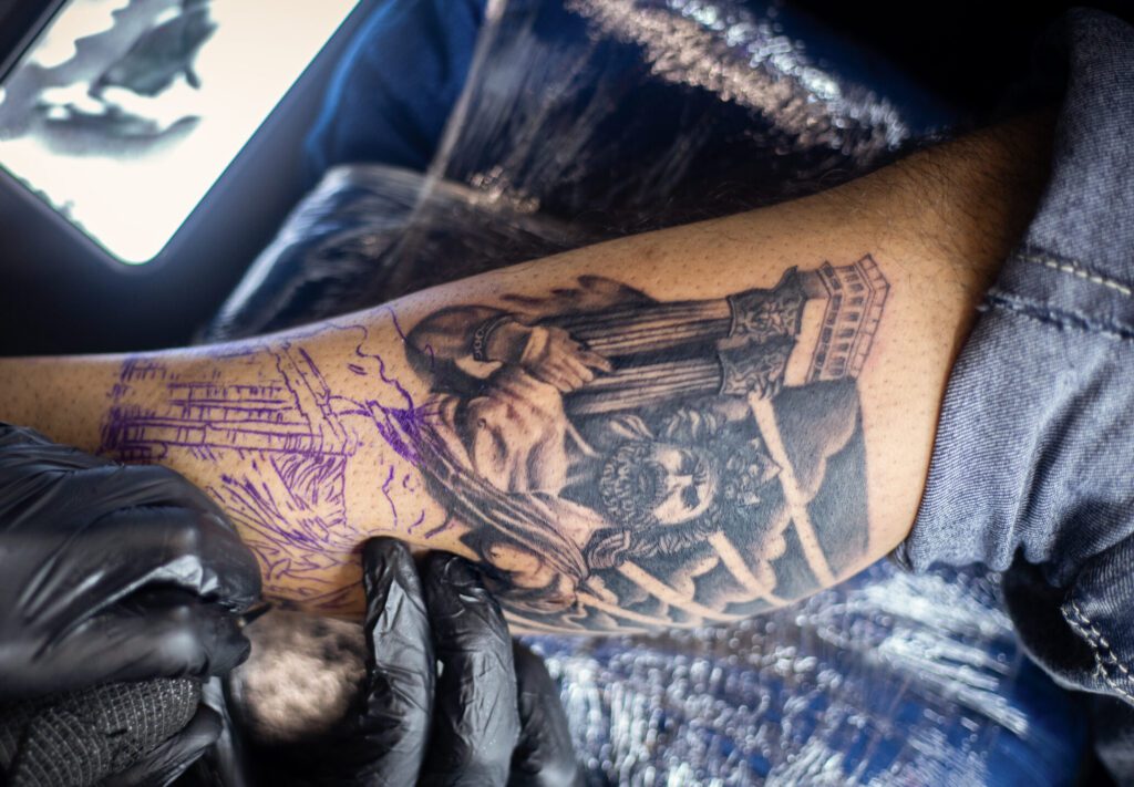 Tattoo training student performing their first tattoo on real skin at Apex Tattooz, best tattoo shop in Delhi