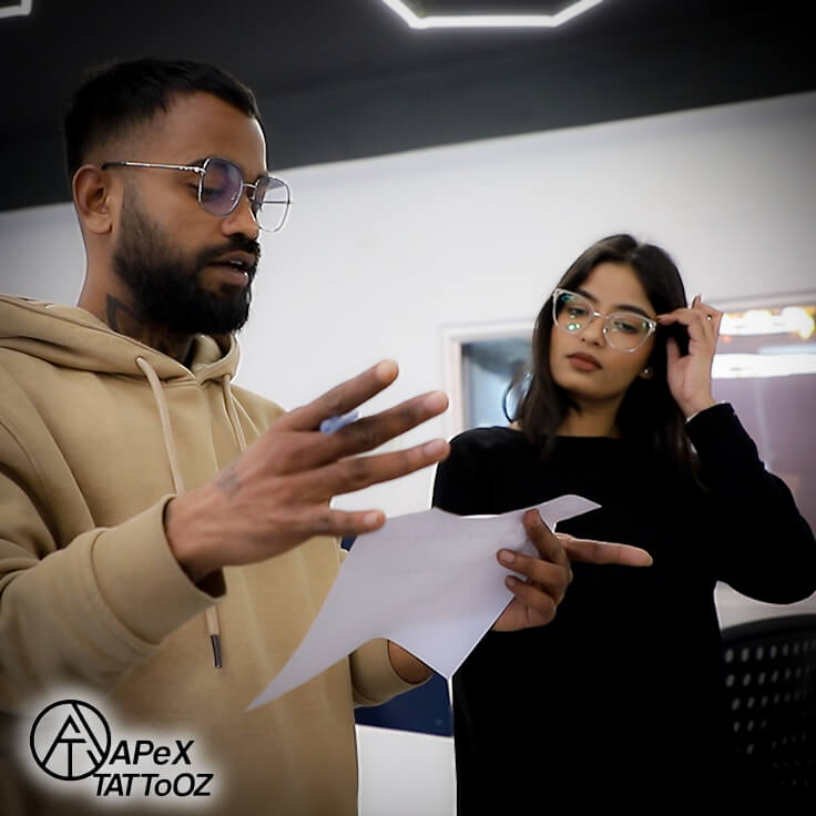 Reviewing custom spine tattoo sketches at Apex Tattooz