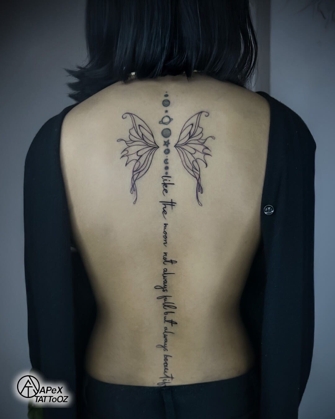 Final reveal of butterfly spine tattoo