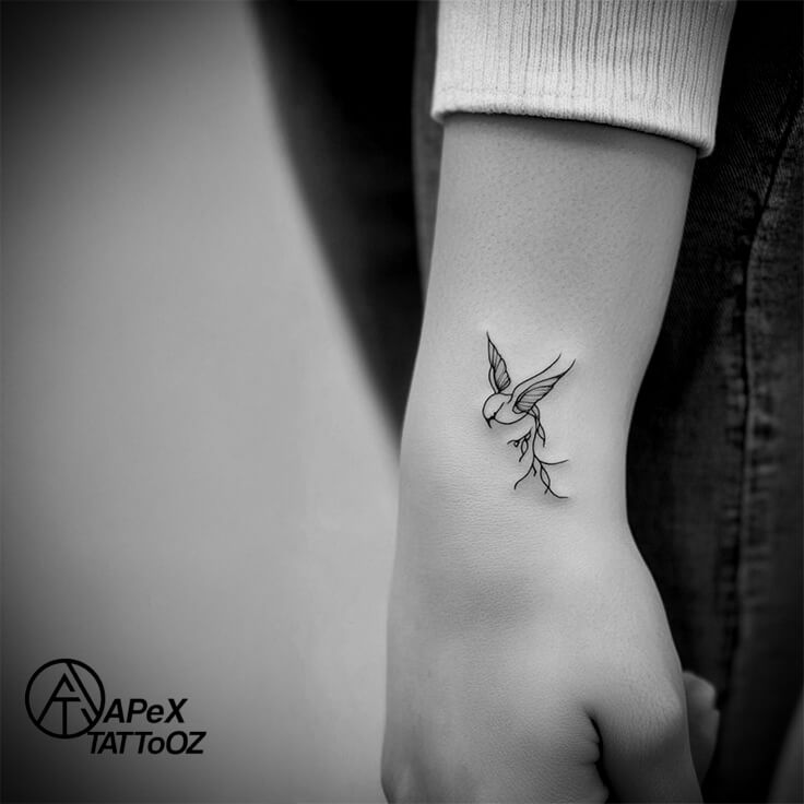 Fine-line bird wrist tattoo