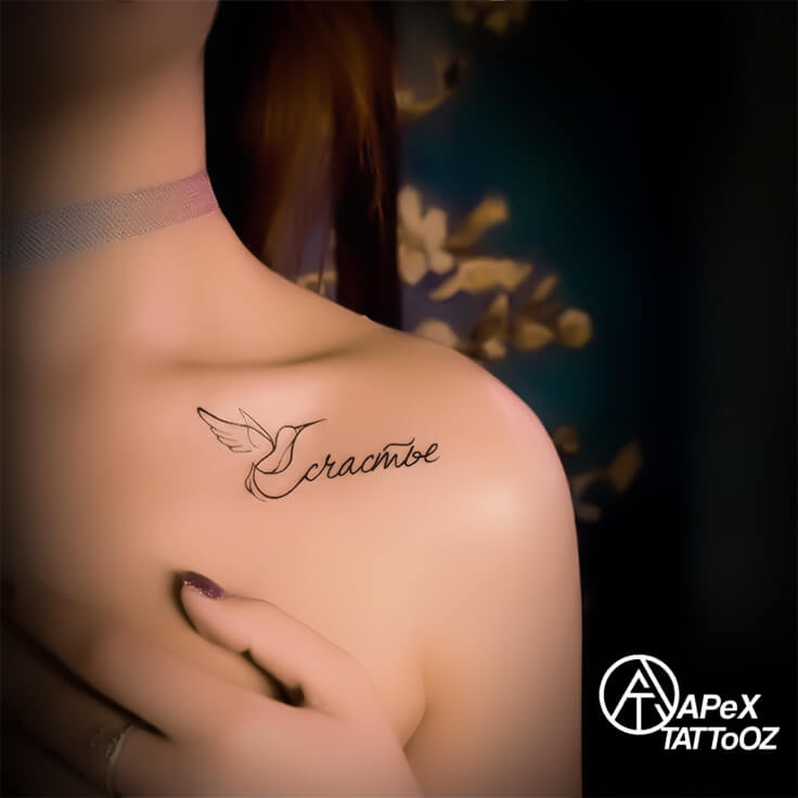 Collarbone script tattoo