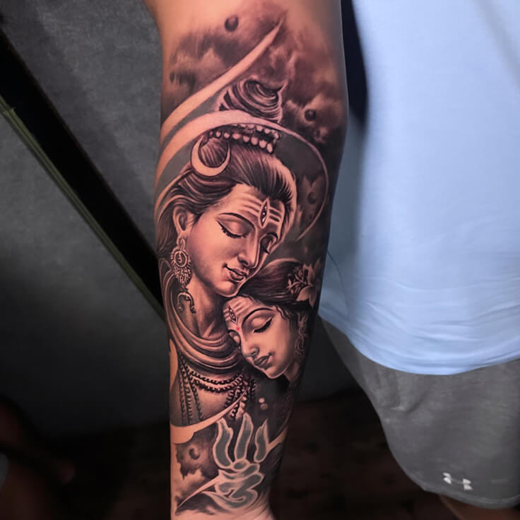 This forearm tattoo beautifully captures the divine union of Shiva and Parvati in black and grey realism.