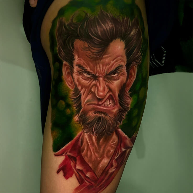 This eye-catching colour tattoo by Soumen Dutta features an intense, exaggerated male expression with hyper-realistic details.