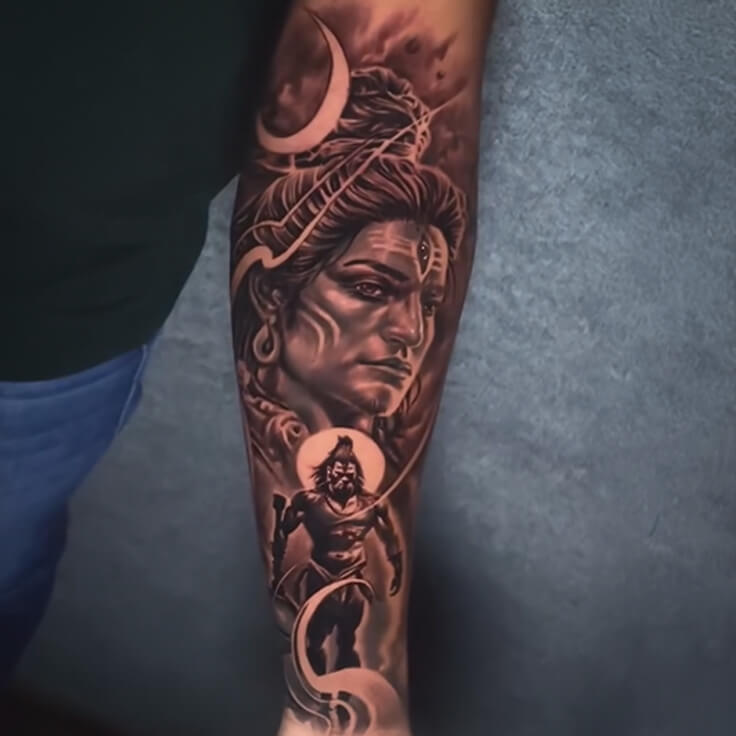 This captivating Shiva tattoo by Soumen Dutta features a forearm-spanning design in hyper-realistic black and grey.