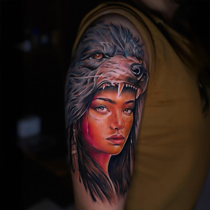 Tribal woman portrait with wolf headdress tattoo by Guru