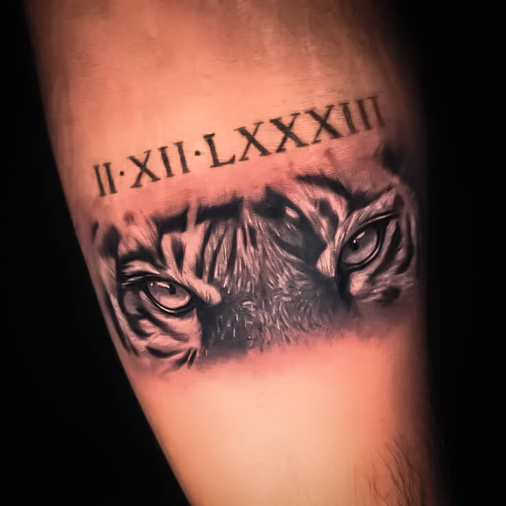 Tiger eyes with Roman numerals tattoo by Sohil Khan