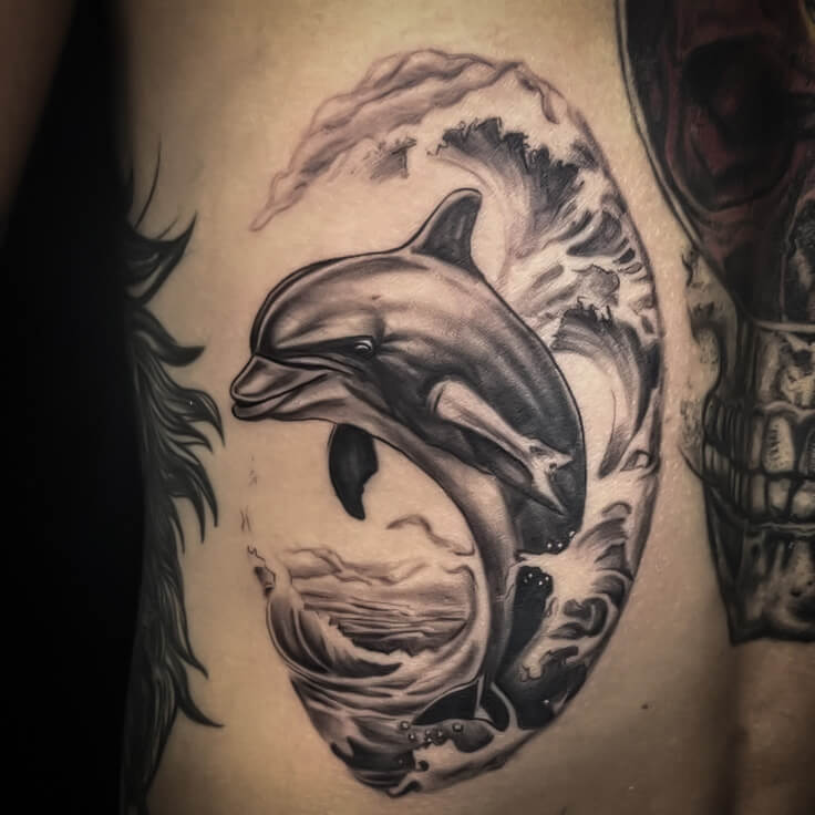 Dolphin and ocean waves tattoo by Gautam Birla