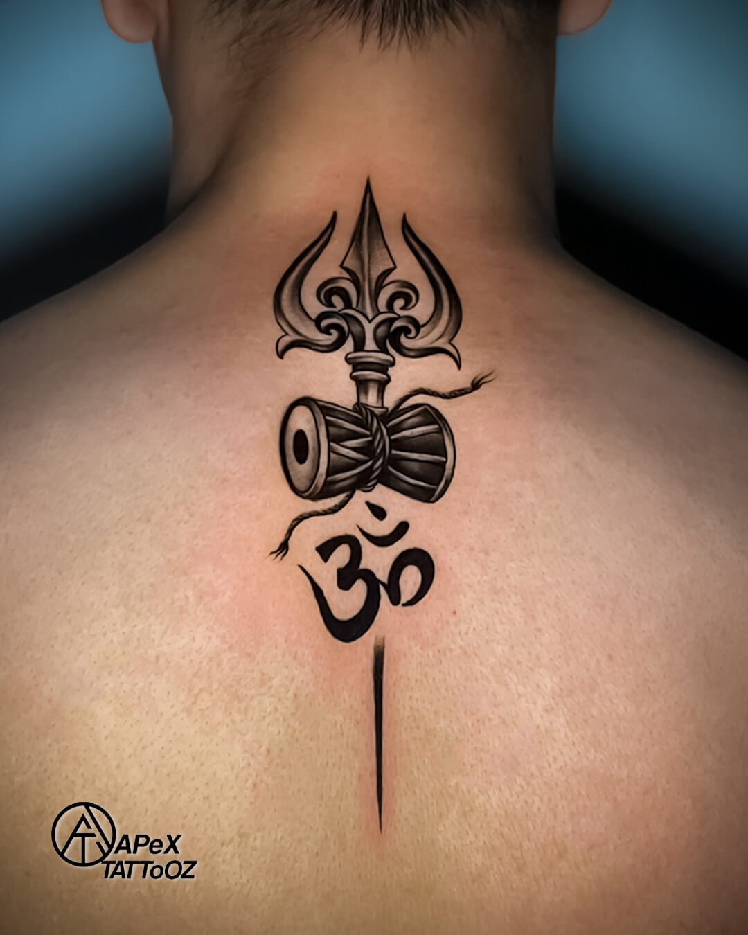 Lord Shiva trishul damru and Om religious back tattoo by Apex Tattooz