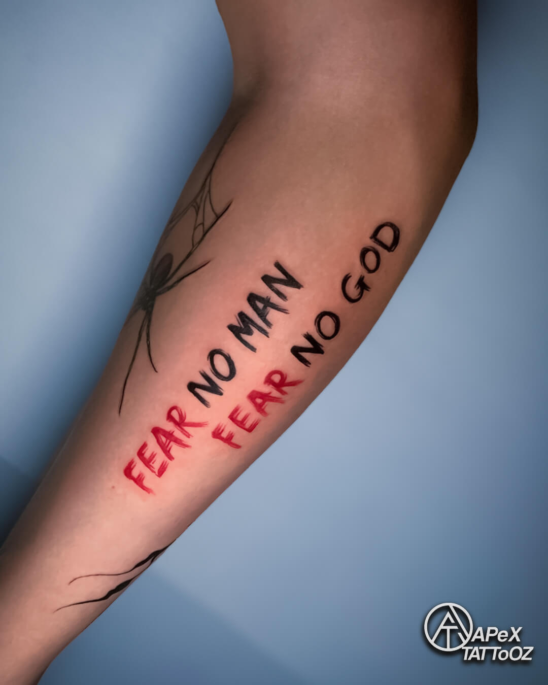 Fear no man motivational lettering forearm tattoo by Apex Tattooz