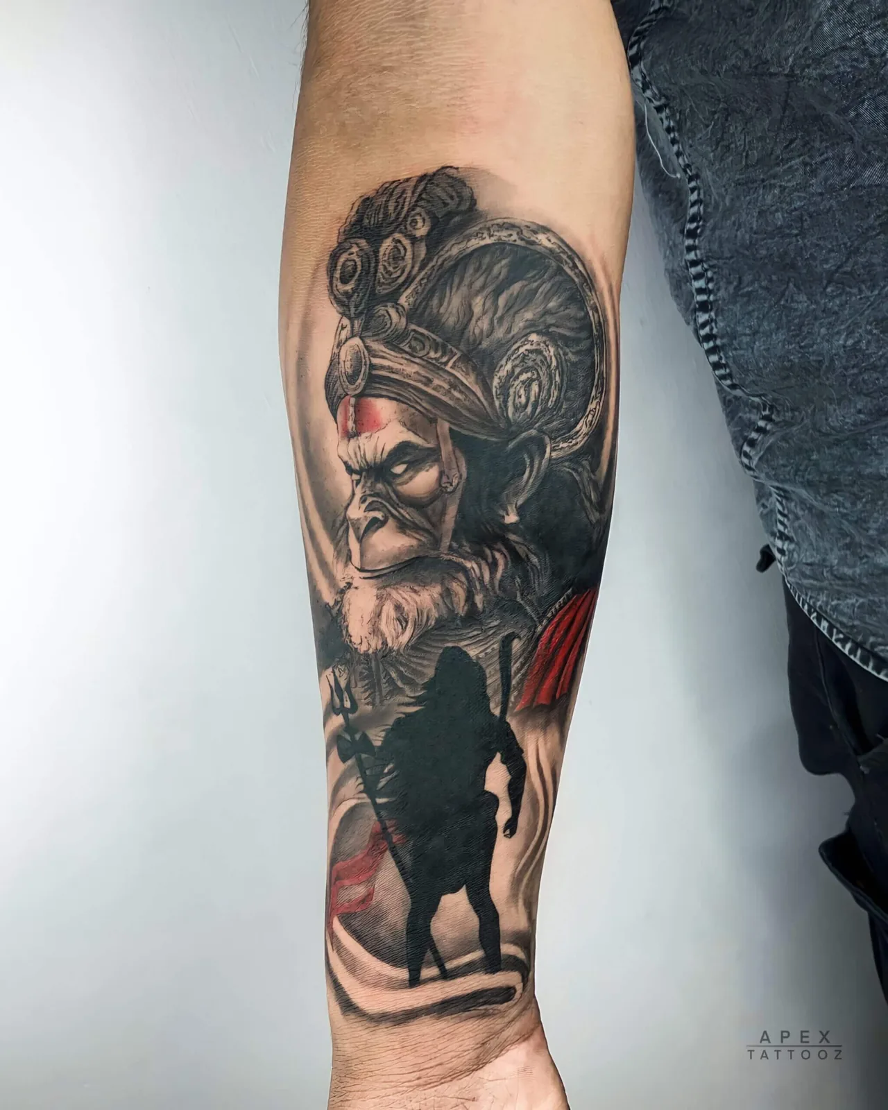 Lord Hanuman black-and-grey forearm tattoo by Apex Tattooz