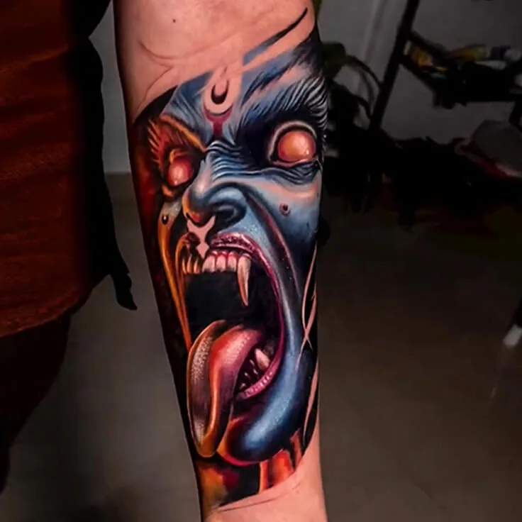 Kali Maa colour-realism forearm tattoo with intense blue and red tones by Apex Tattooz