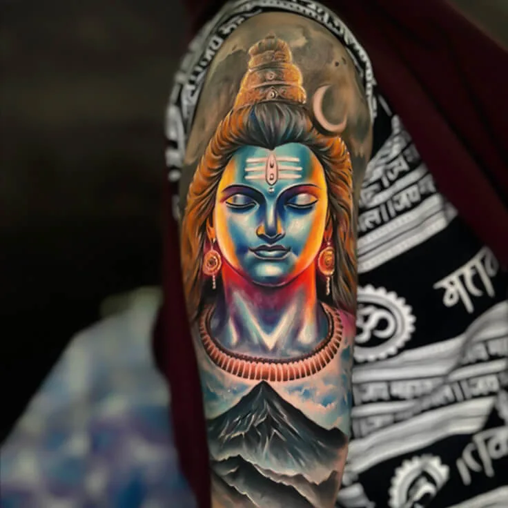 Colour-realism Shiva tattoo with mountain background by Apex Tattooz