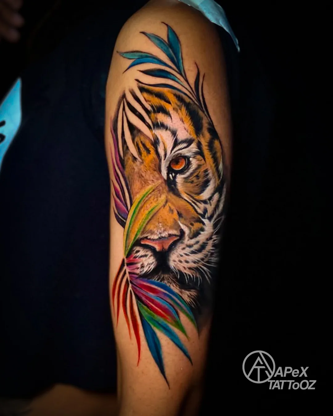 Colour realism tiger tattoo with abstract leaves by Tanmay in Delhi
