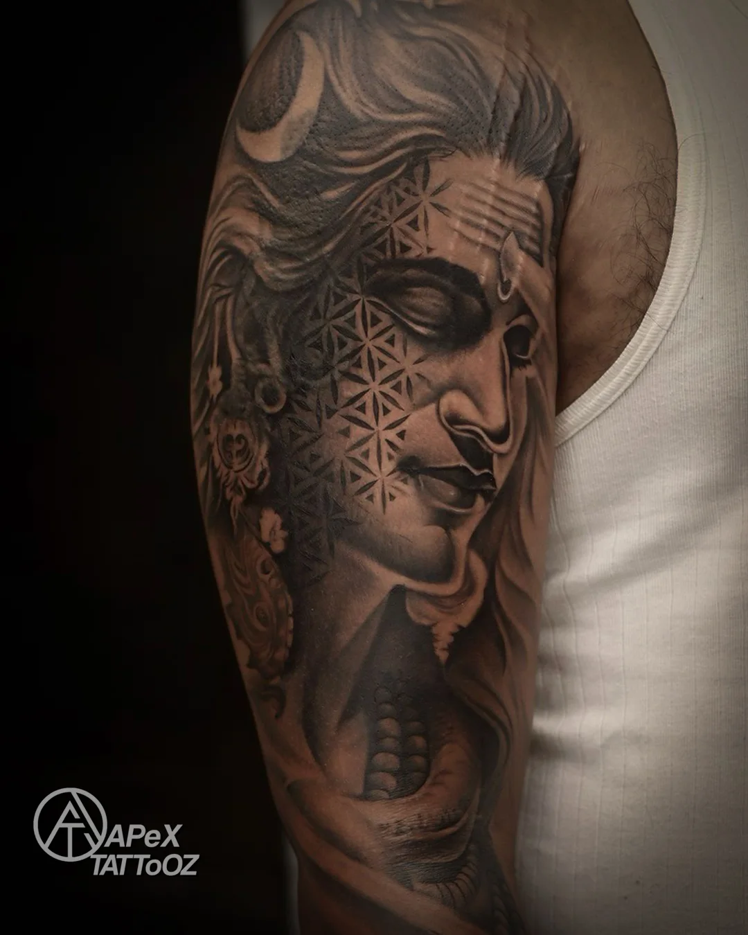 Black and grey Shiva realism upper arm tattoo by Tanmay in Delhi