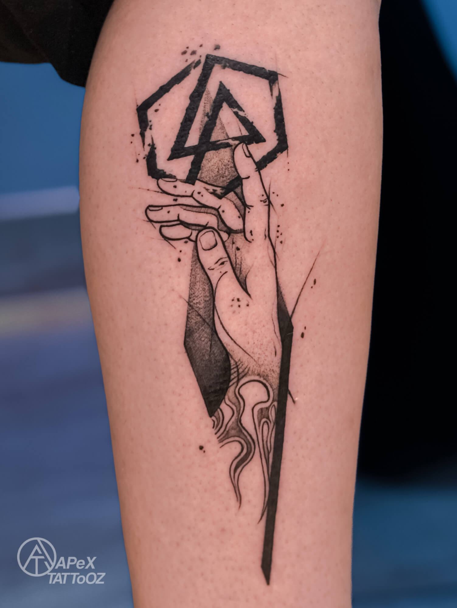 Linkin Park symbol above a hand illustration with fine linework and a tapered black shape