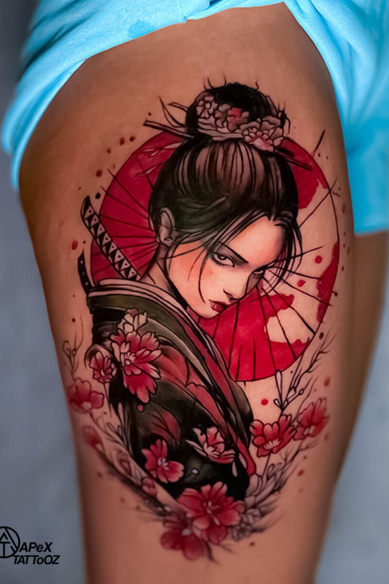Japanese geisha tattoo on thigh with red floral and umbrella — custom work by Apex Tattooz Delhi